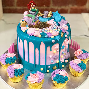 Little mermaid pink with blue drip kids cake with mini cupcakes
